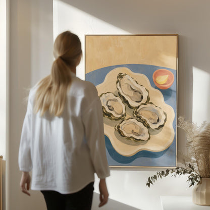 Four open oysters on a cream platter with lemon on a dusty blue ground, canvas wall art hanging in a calm, modern living space