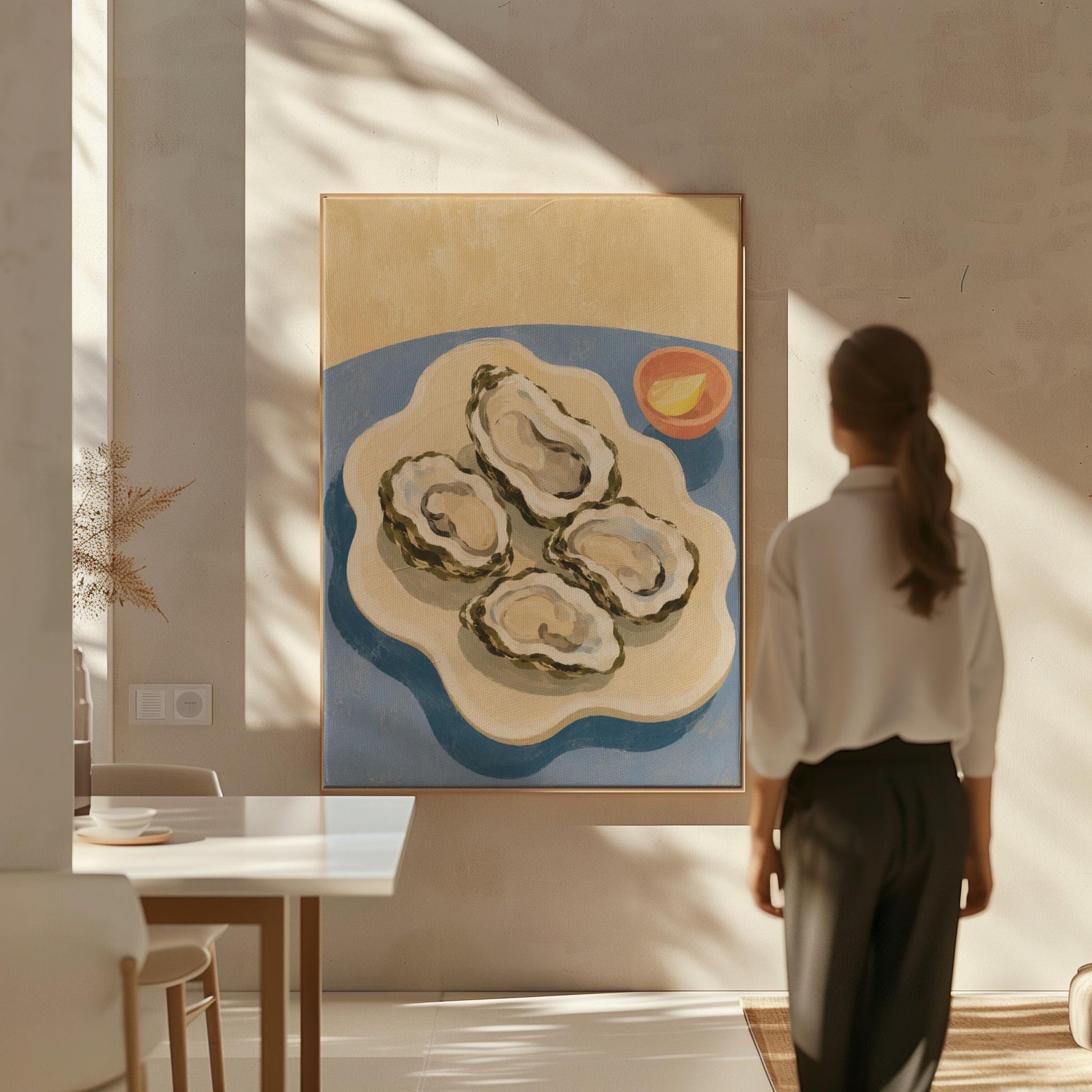 Four open oysters on a cream platter with lemon on a dusty blue ground, canvas wall art presented in a light, minimal room