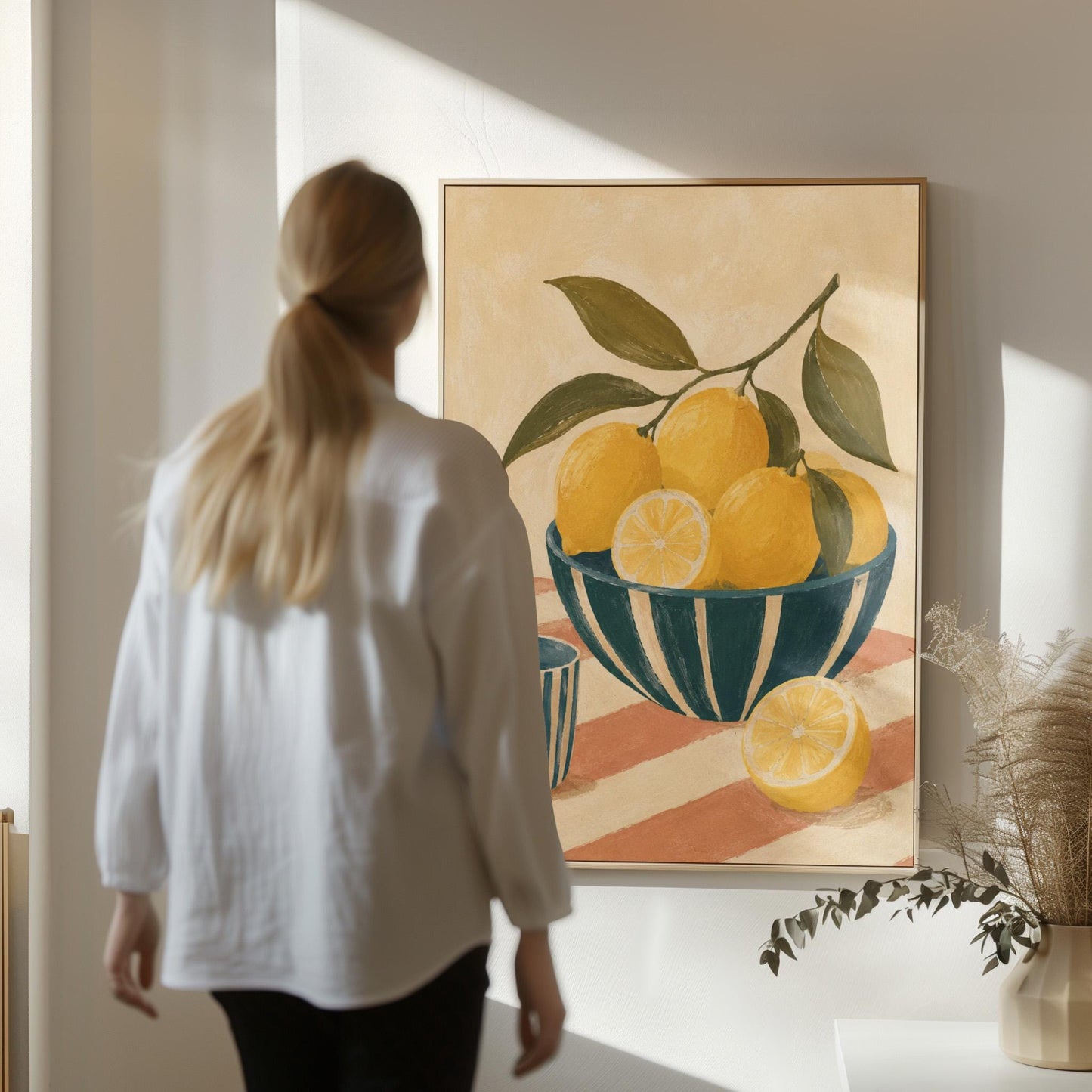 Lemons on the branch in a teal striped bowl on a pink striped cloth, canvas print seen in a warm interior with natural light
