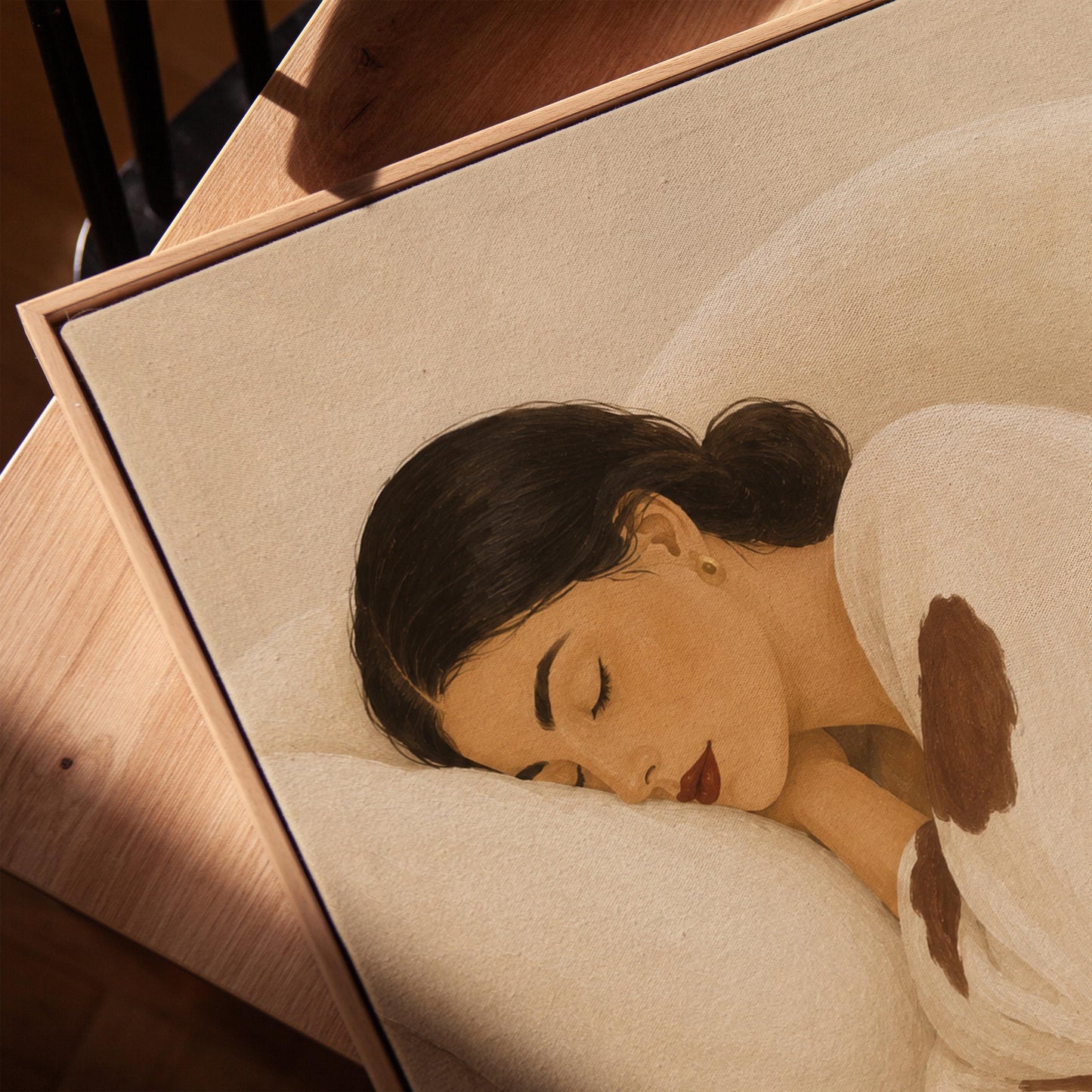 Woman asleep on a pillow under a cream blanket with brown markings, canvas print in a warm, minimally styled interior
