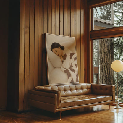 Woman asleep on a pillow under a cream blanket with brown markings, canvas print displayed on a neutral wall in a styled interior