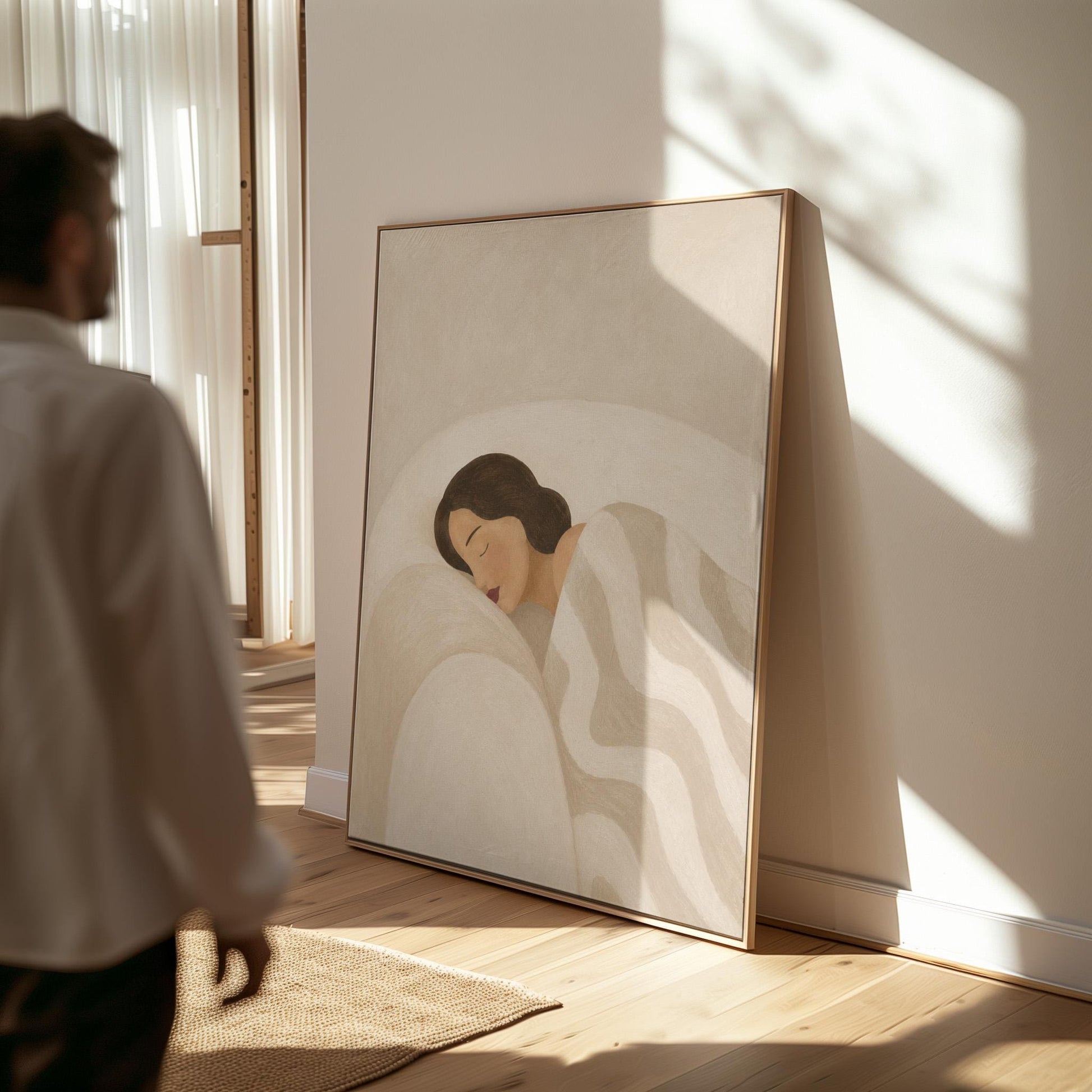 Woman asleep beneath a quilt of rolling cream and sand wave shapes, canvas wall art hanging in a calm, modern living space