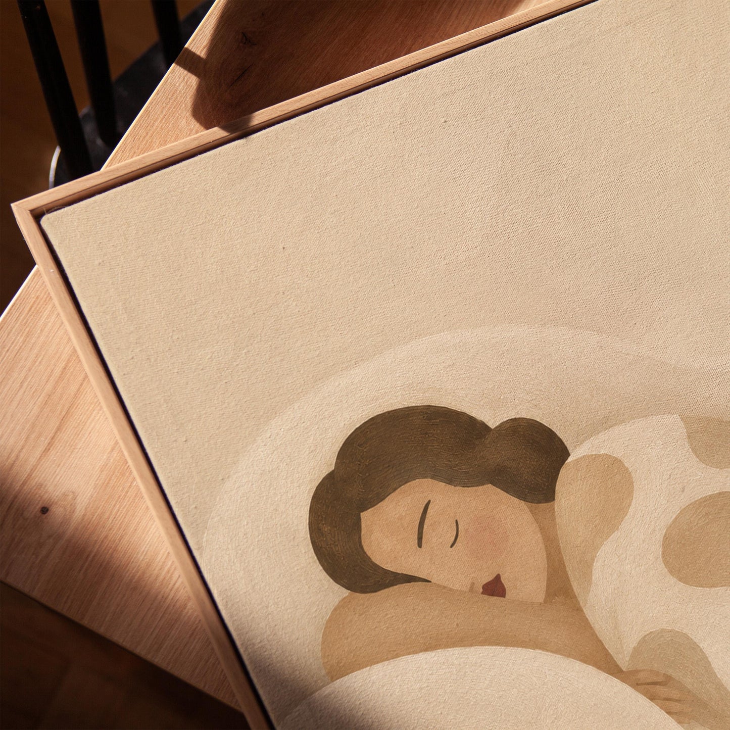 Woman sleeping under a cream blanket with soft camel cloud shapes, canvas print in a warm, minimally styled interior