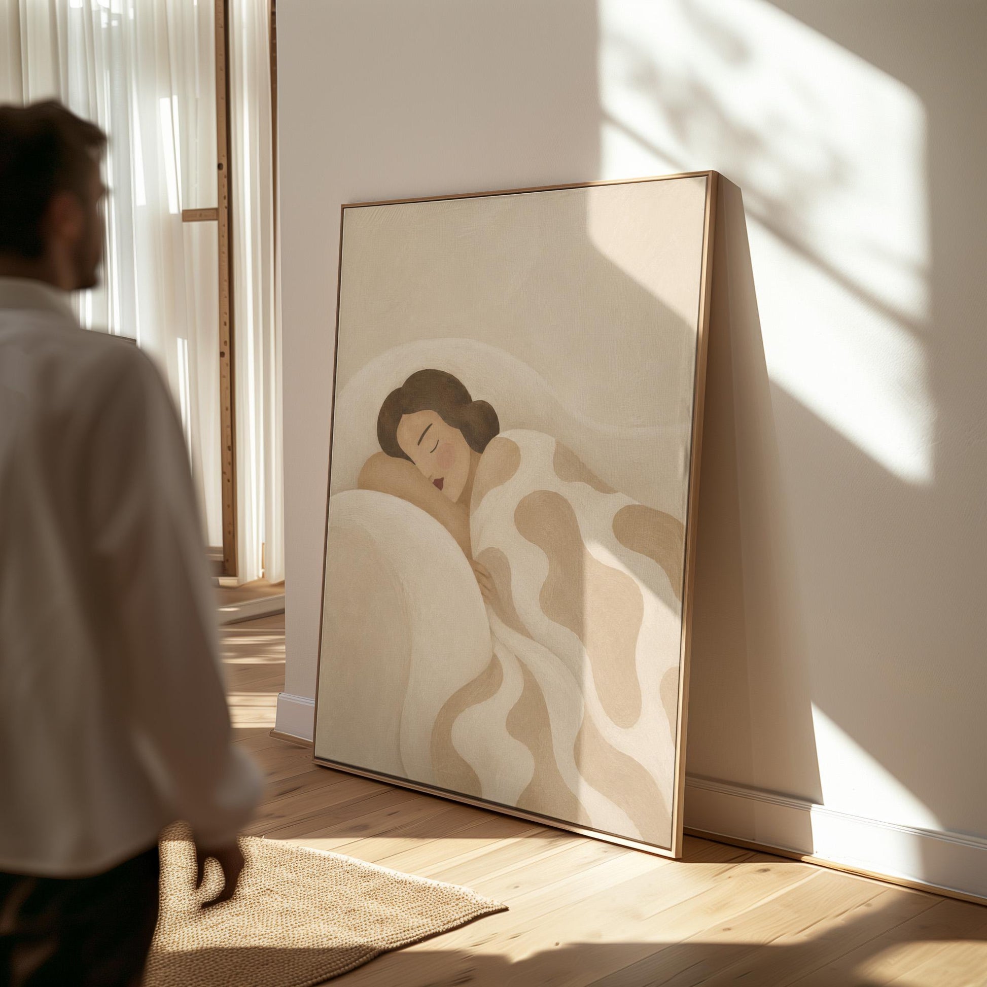 Woman sleeping under a cream blanket with soft camel cloud shapes, canvas print shown to scale in a furnished room
