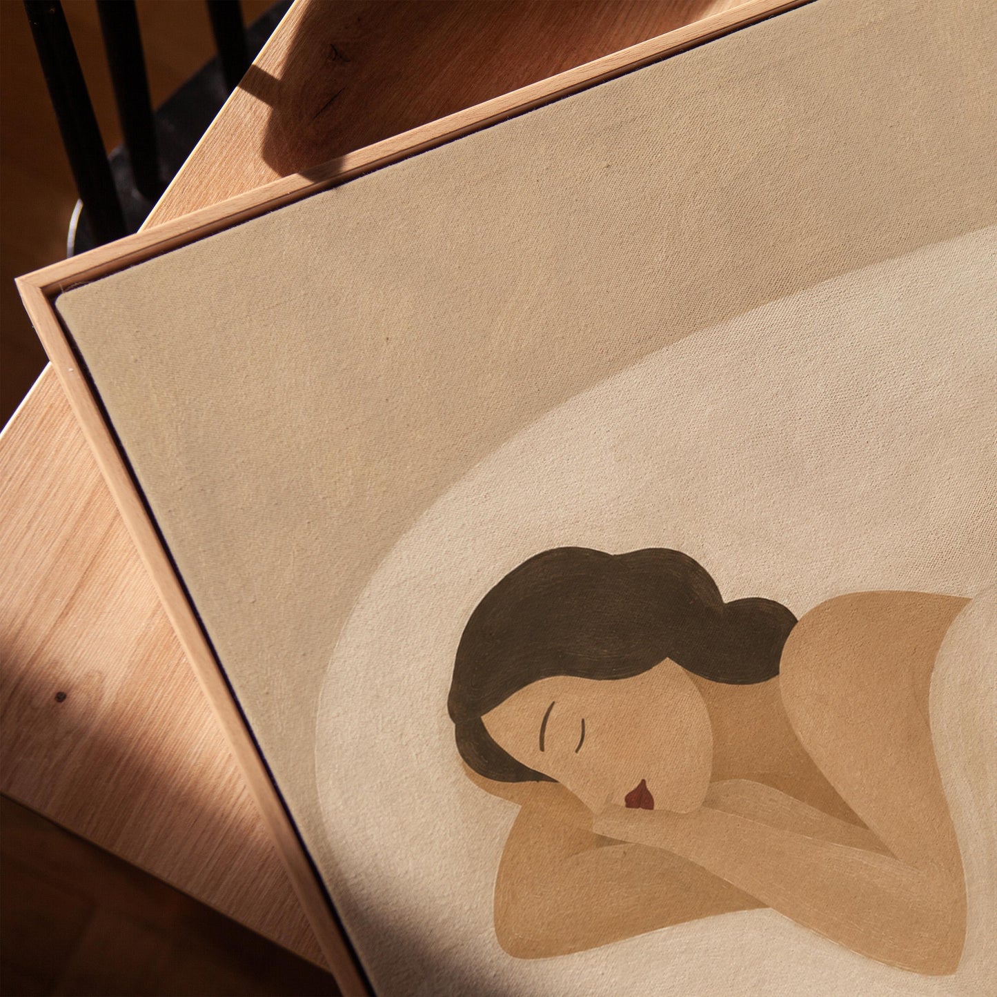 Woman sleeping with a small white cat curled at the foot of the bed, canvas print in a warm, minimally styled interior