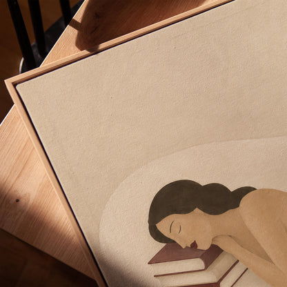 Woman resting her cheek on a stack of cream and burgundy books, canvas print in a warm, minimally styled interior