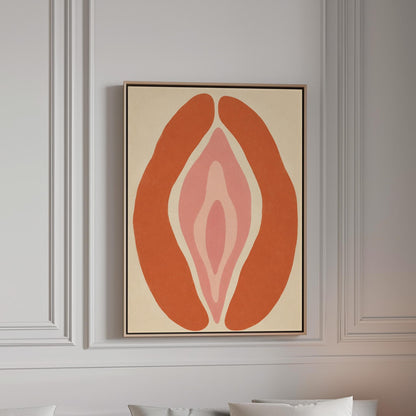 Rust orange arcs curving around a nested blush pink core on sand, canvas print in a bright room with natural daylight