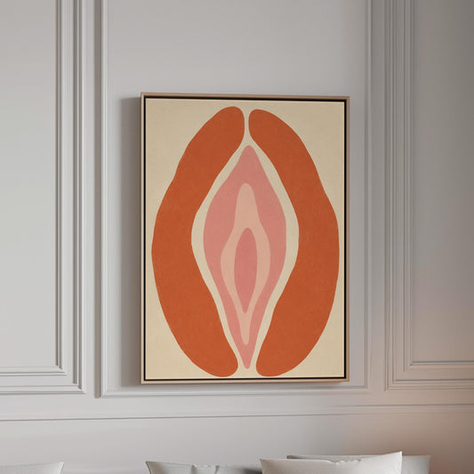 Rust orange arcs curving around a nested blush pink core on sand, canvas print in a bright room with natural daylight