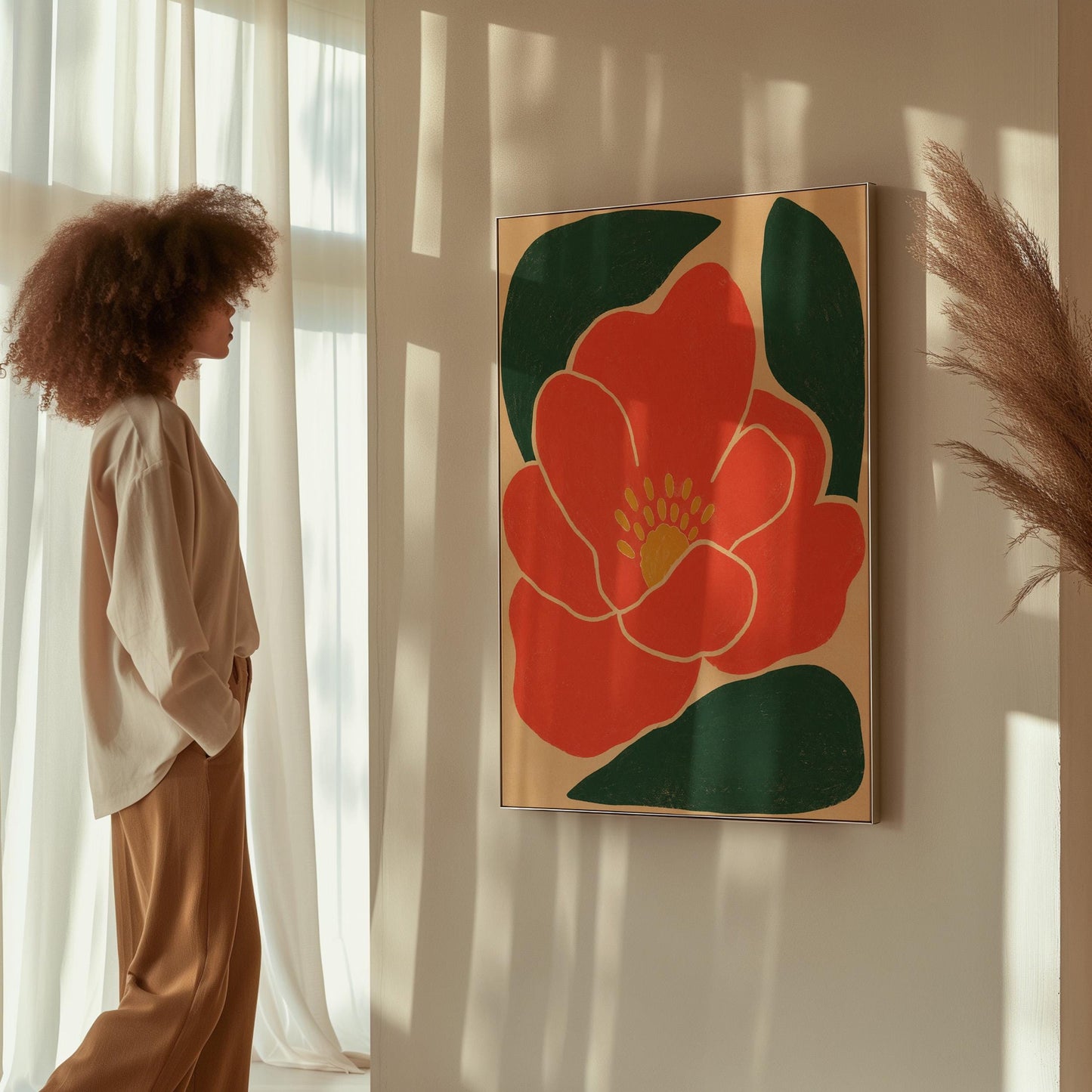 Scarlet flower with gold stamens over deep green leaves on sand, canvas print shown to scale in a furnished room