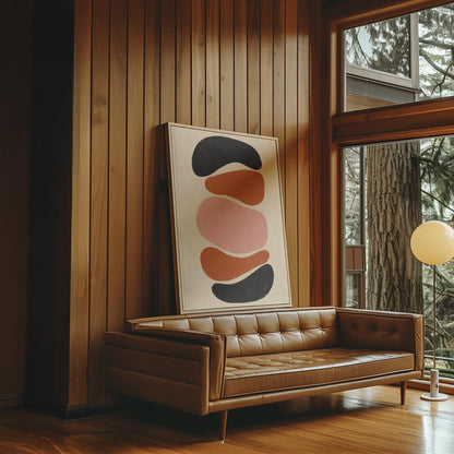 Five stacked pebble shapes in charcoal rust and blush on cream, canvas print presented in a light, minimal room