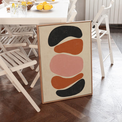 Five stacked pebble shapes in charcoal rust and blush on cream, canvas wall art presented in a light, minimal room
