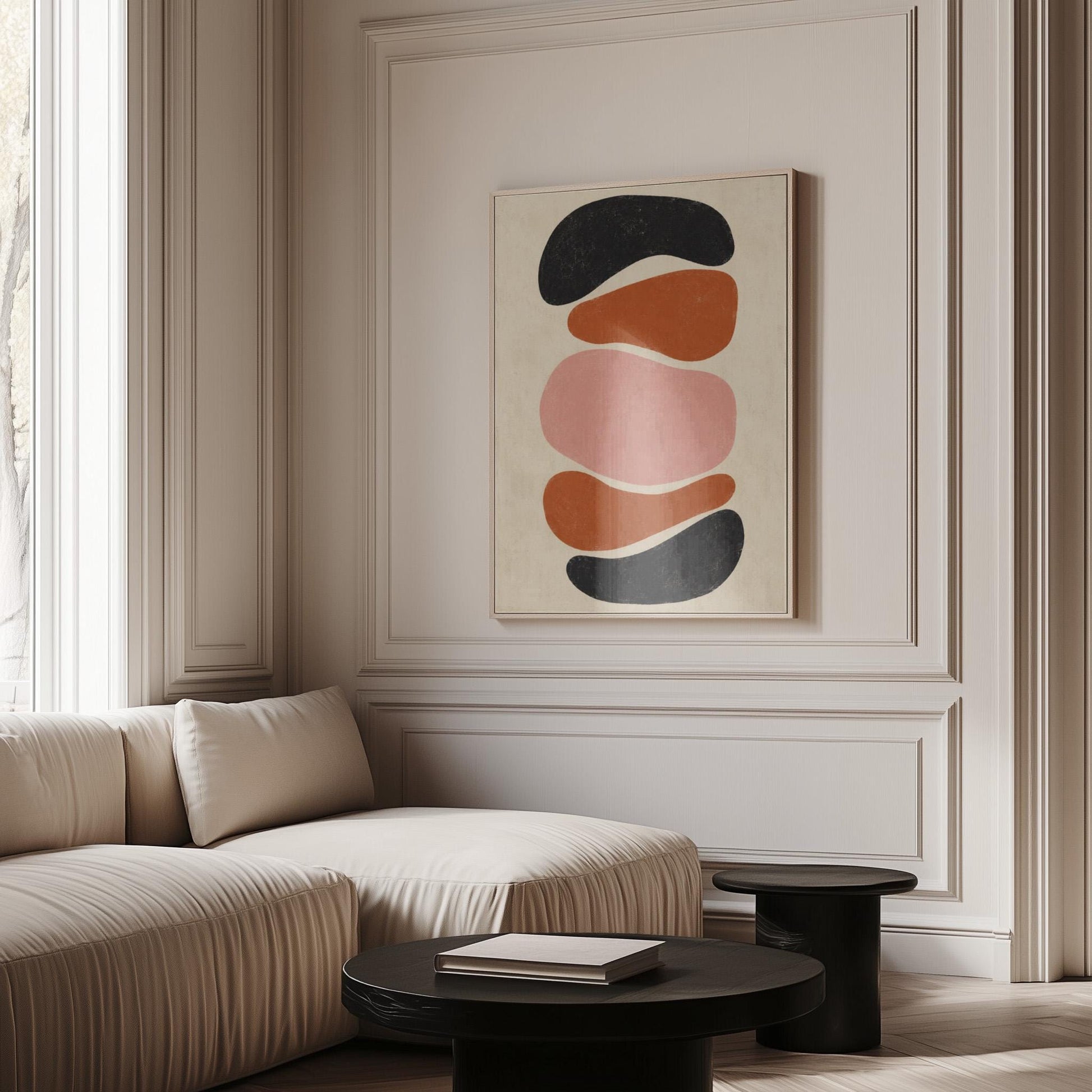Five stacked pebble shapes in charcoal rust and blush on cream, canvas wall art on a quiet wall in a considered interior