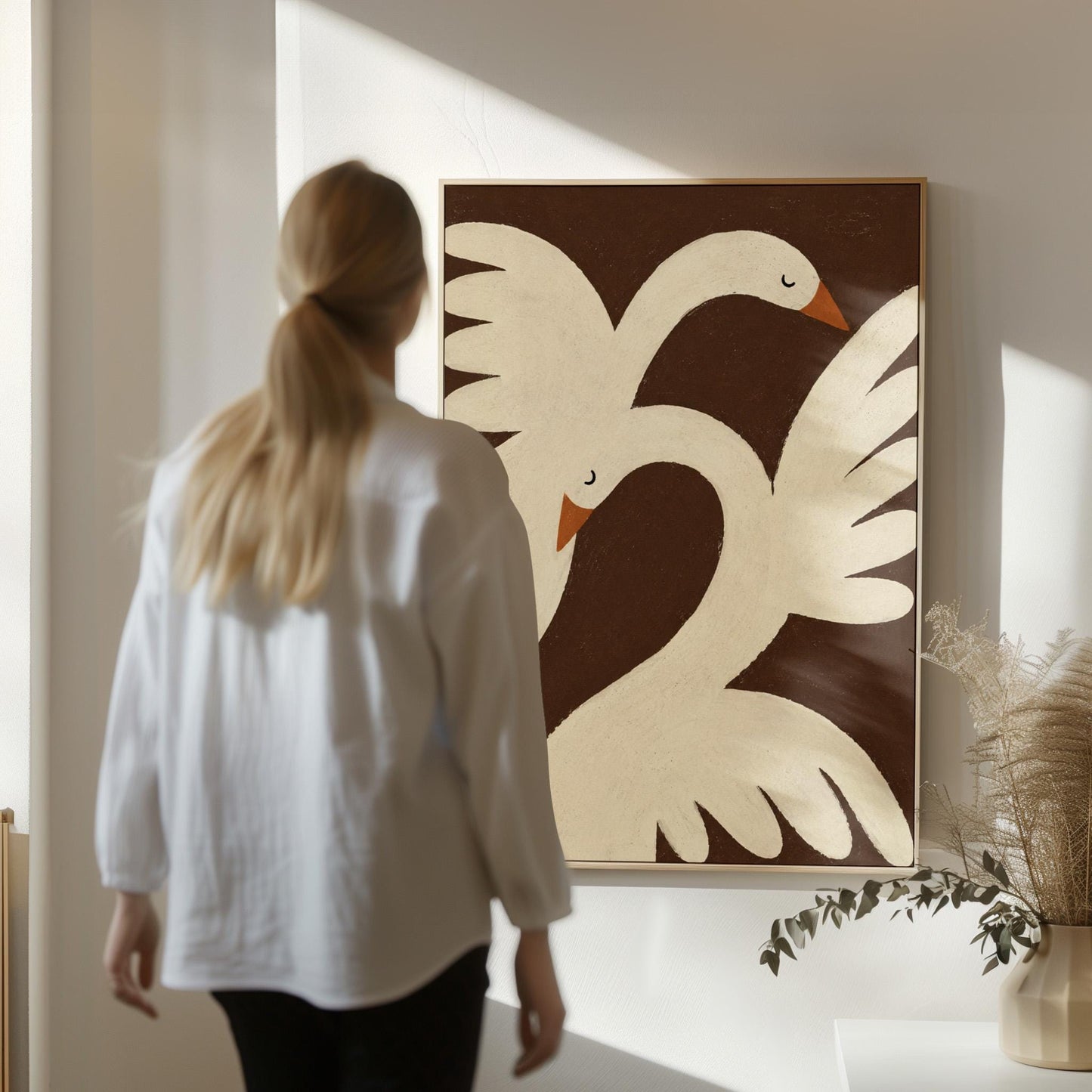 Two cream doves with orange beaks crossing wings on dark brown, canvas print styled against a soft white wall
