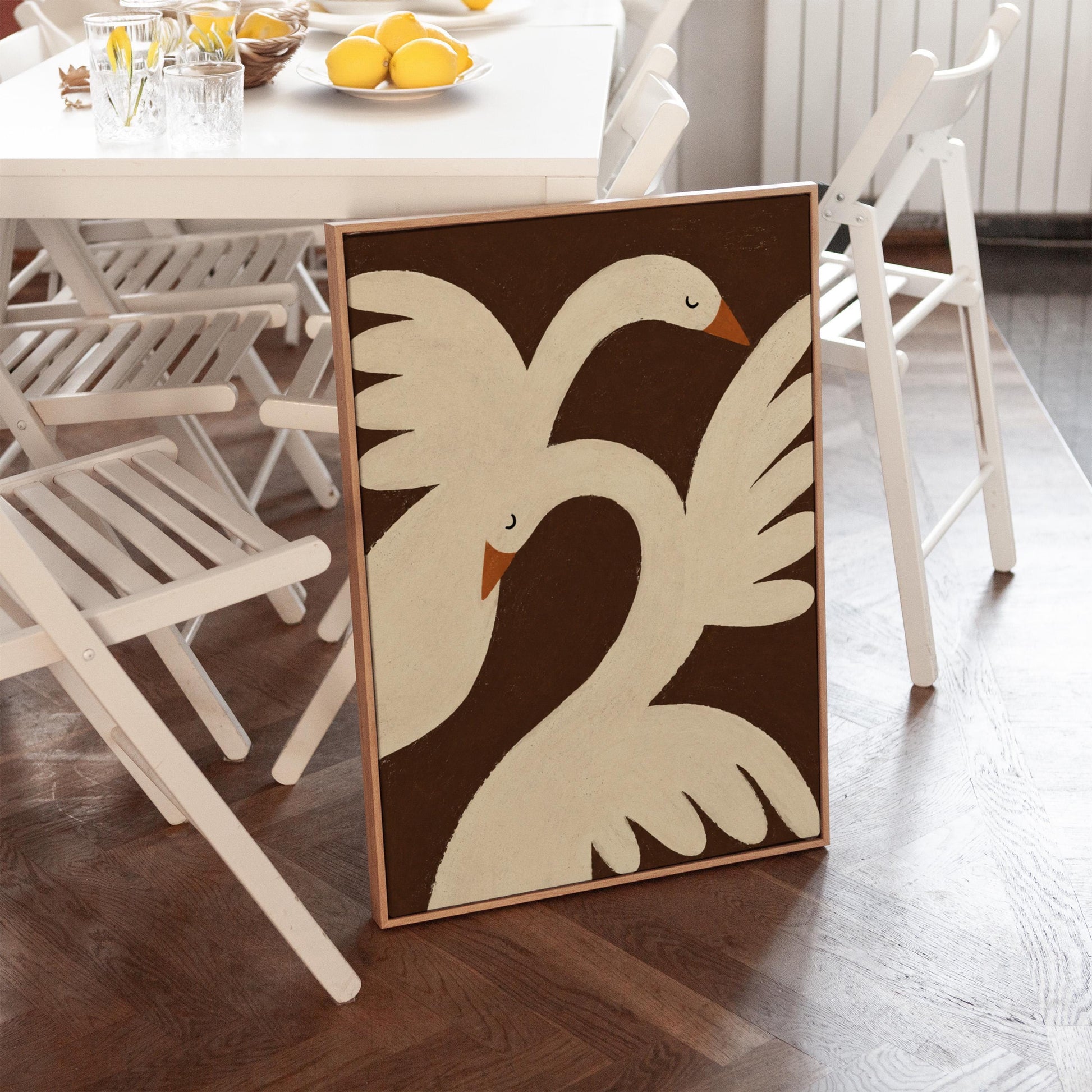 Two cream doves with orange beaks crossing wings on dark brown, canvas print on a quiet wall in a considered interior