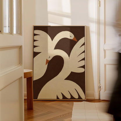 Two cream doves with orange beaks crossing wings on dark brown, canvas wall art hanging in a calm, modern living space