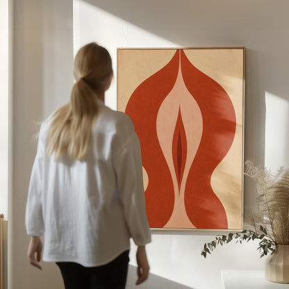 Rust red flame shaped form opening into blush and grey on sand, canvas print shown in a sunlit, contemporary room