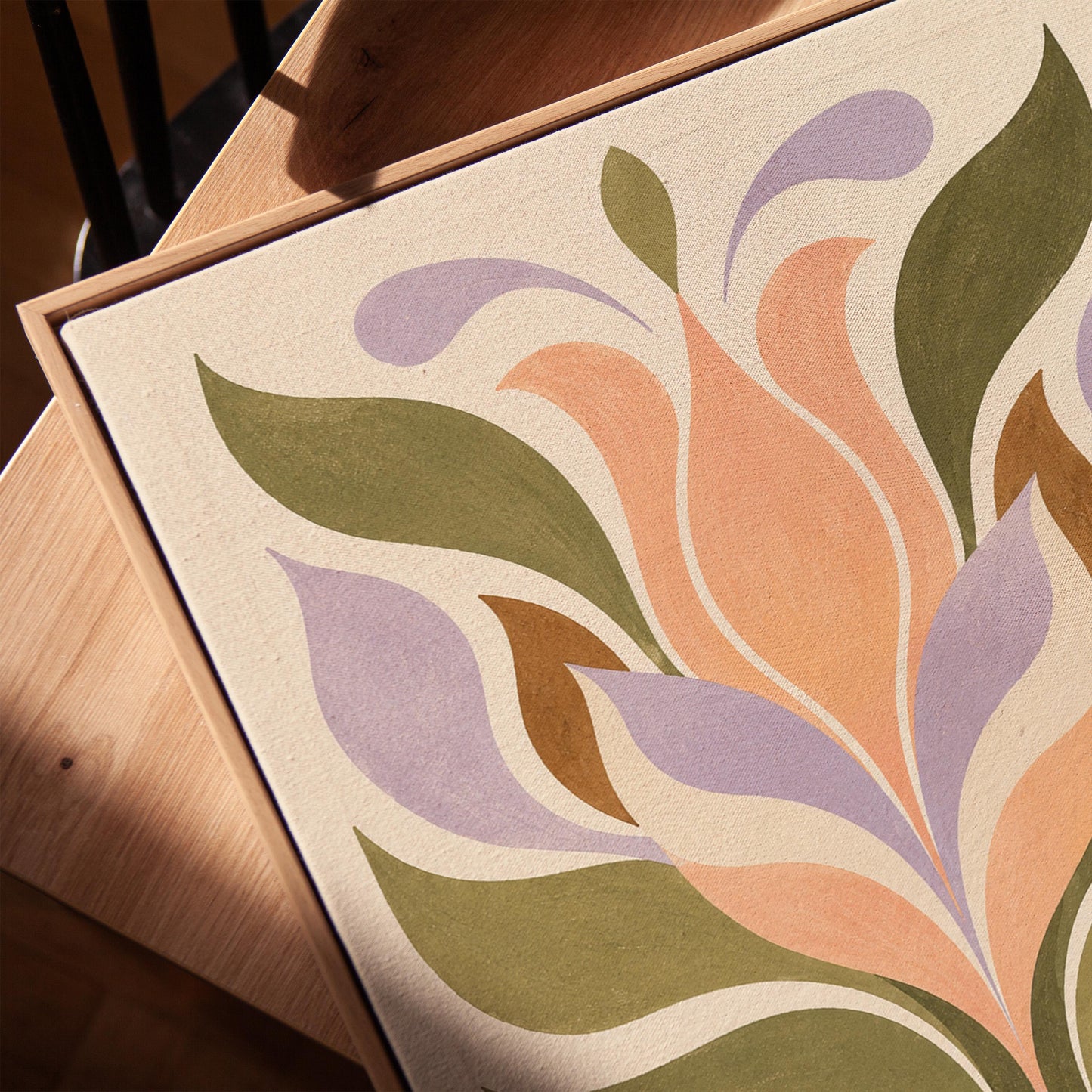 Symmetrical folk tulip motif in olive lilac and peach on cream, canvas print in a warm, minimally styled interior