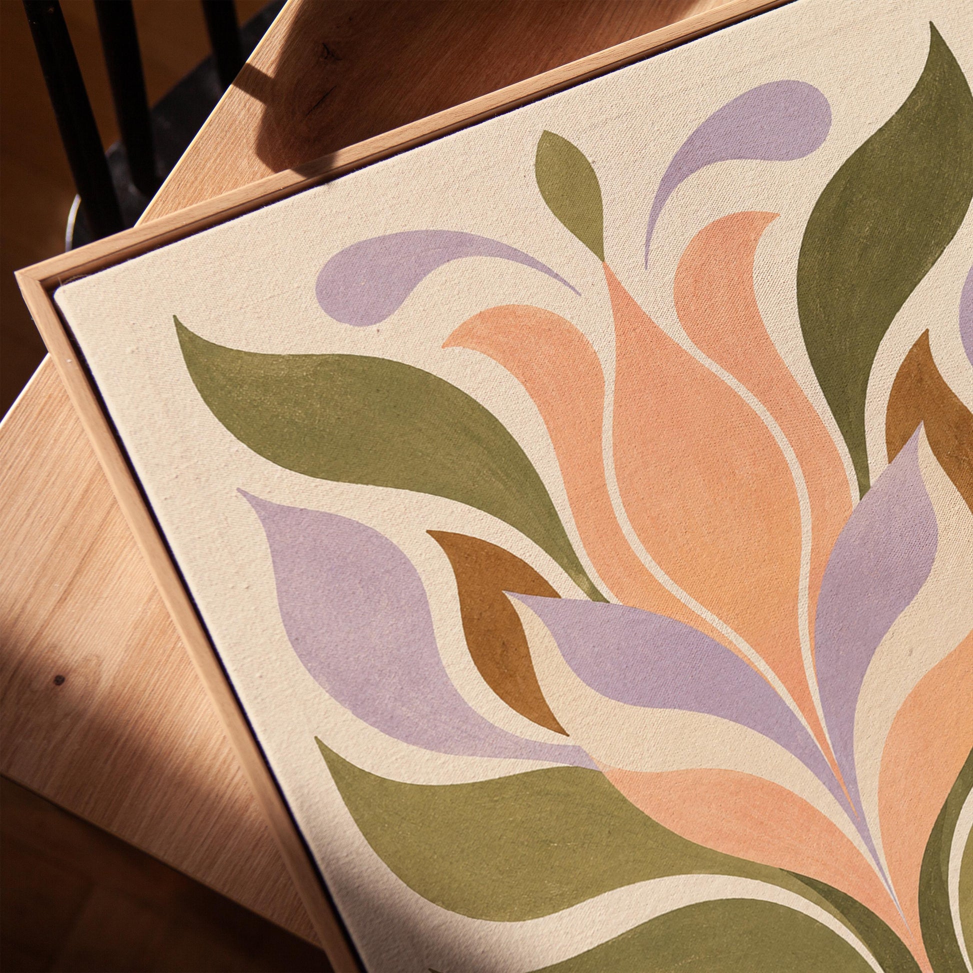 Symmetrical folk tulip motif in olive lilac and peach on cream, canvas print in a warm, minimally styled interior