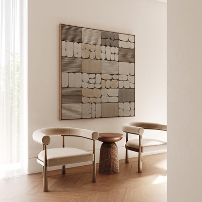 a modern living room with a large abstract artwork on the wall, two white armchairs, and a small side table.
