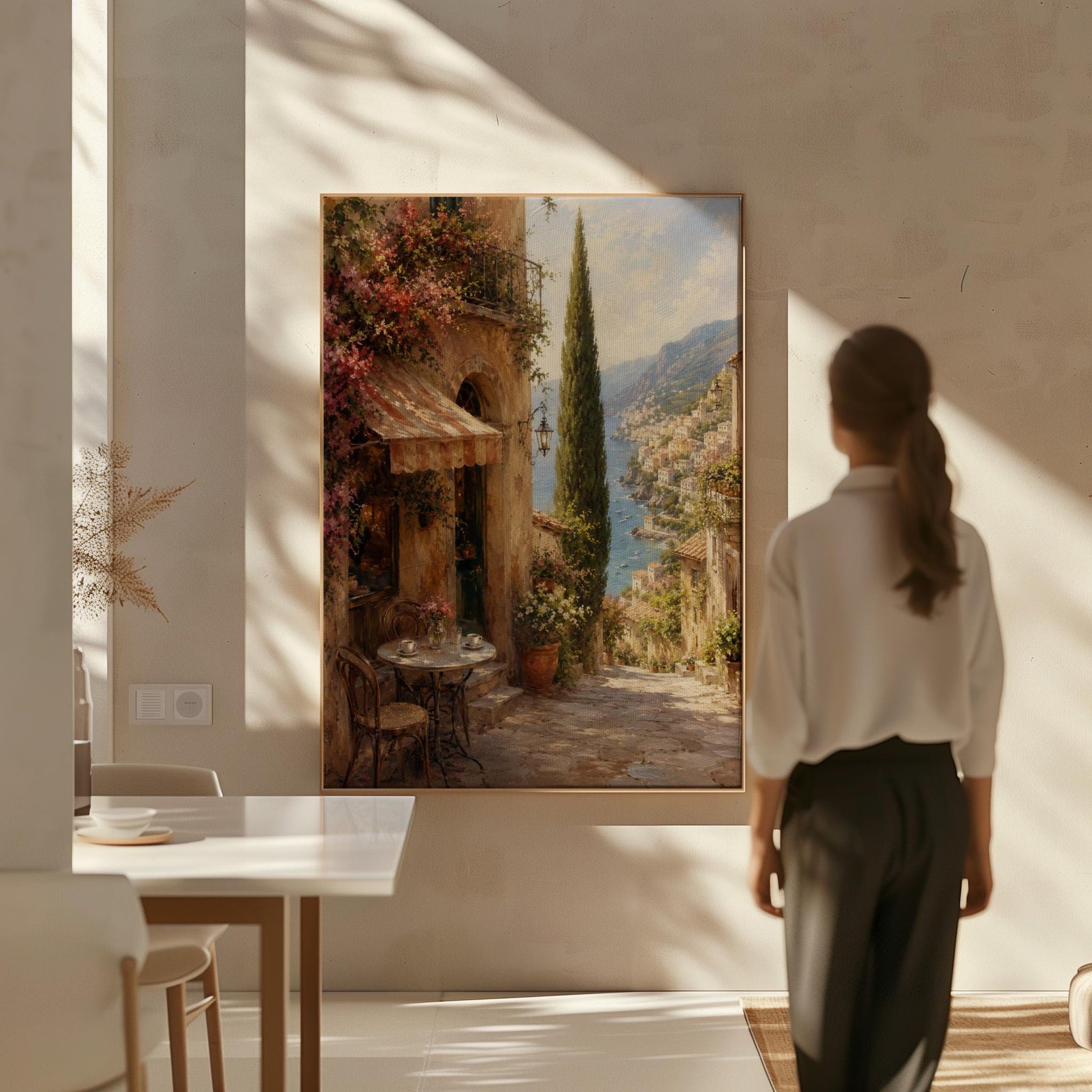 Italian village cafe painting with striped awning and coastal view, canvas print on a quiet wall in a considered interior