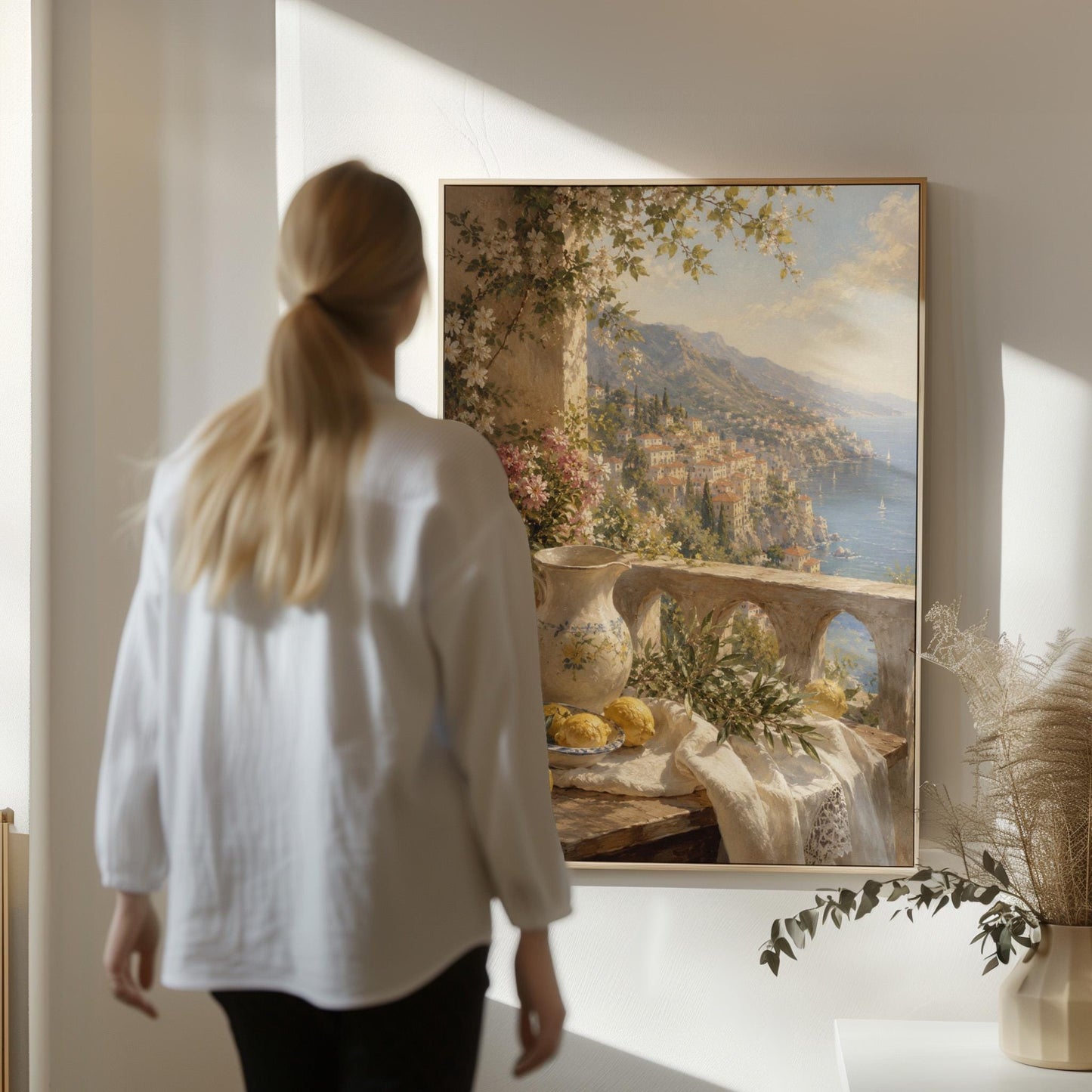 Lemon still life with a ceramic pitcher on an Italian balcony, canvas wall art styled against a soft white wall