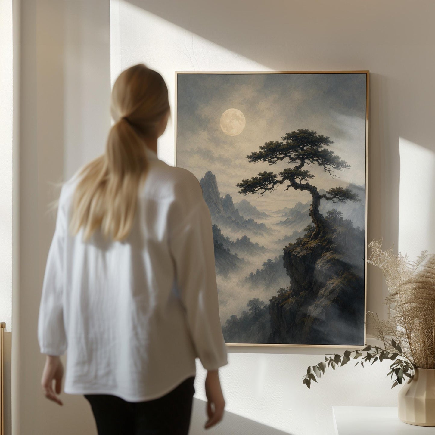Moonlit misty mountains with a windswept pine tree, canvas print presented in a light, minimal room