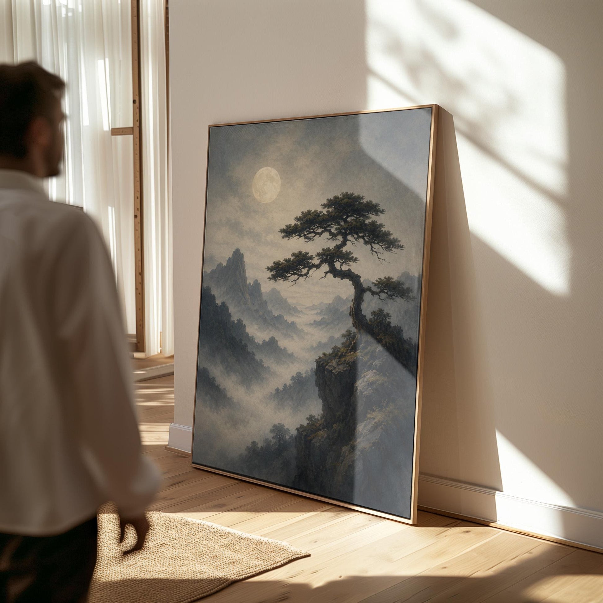 Moonlit misty mountains with a windswept pine tree, canvas print displayed on a neutral wall in a styled interior