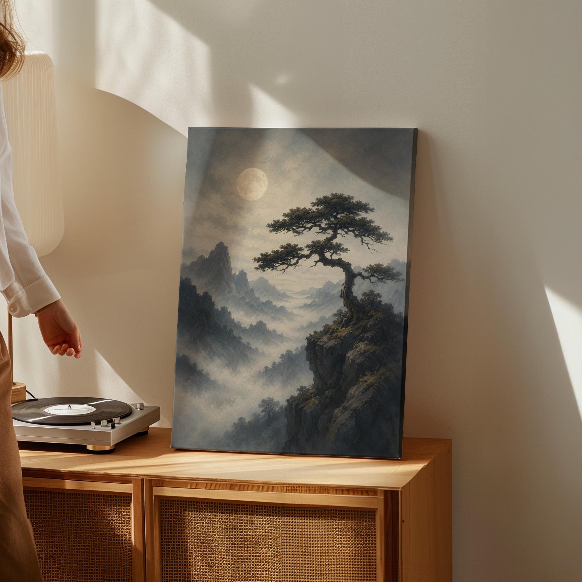 Moonlit misty mountains with a windswept pine tree, canvas wall art on a quiet wall in a considered interior