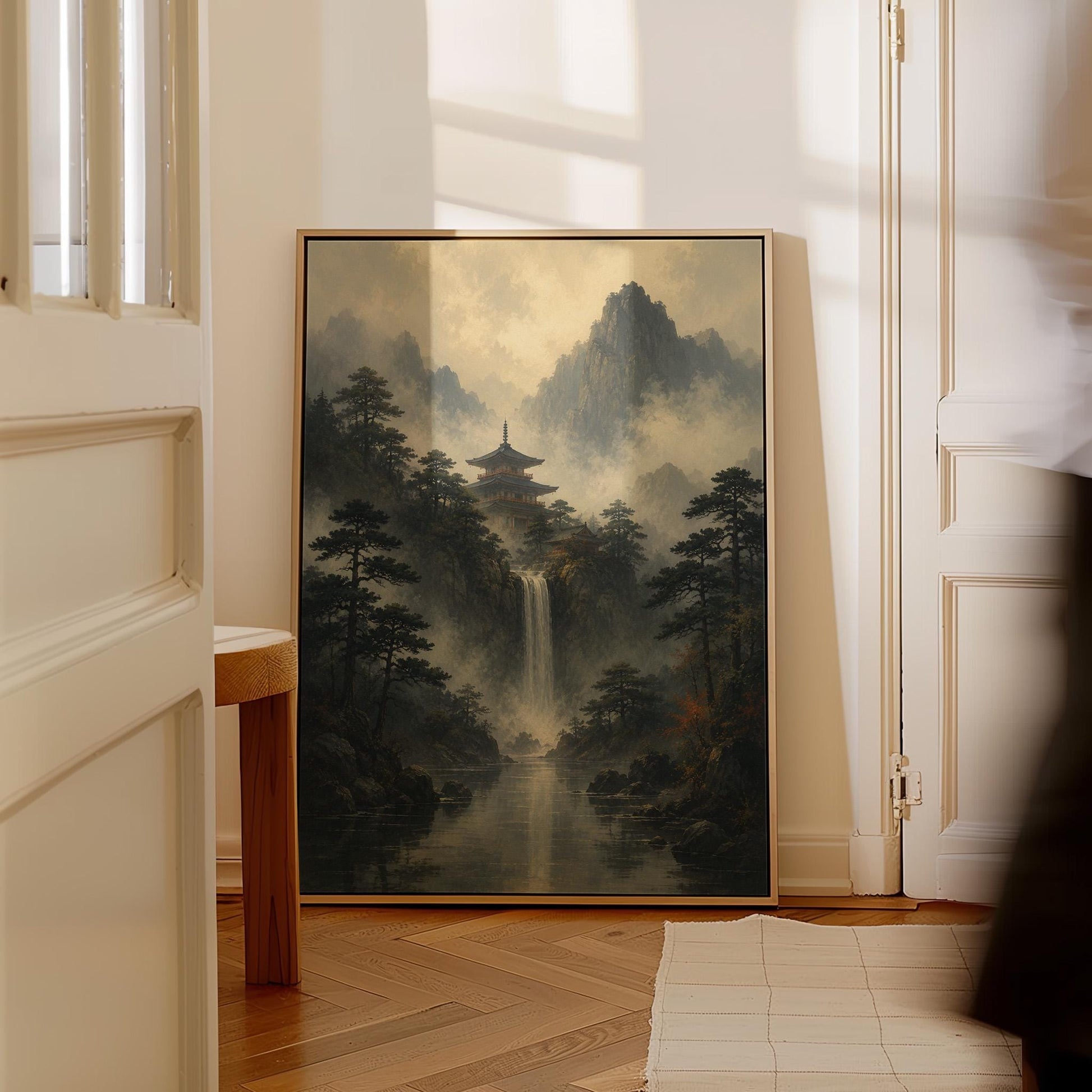 Japanese pagoda above a waterfall in misty pine forest, canvas print shown in a sunlit, contemporary room