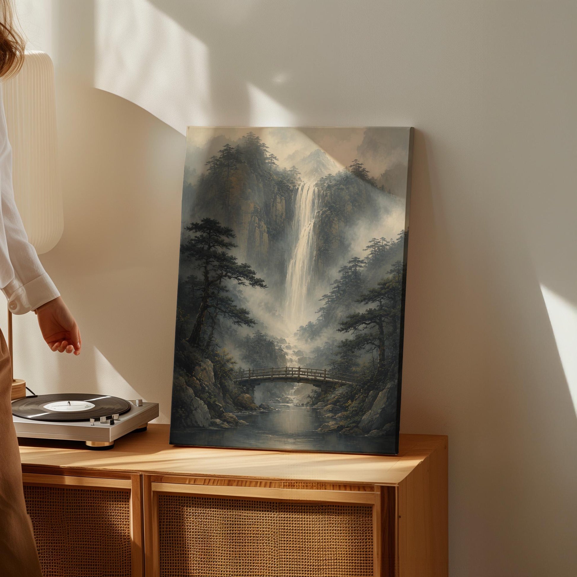 Tall waterfall and wooden bridge in a misty gorge, canvas print on a quiet wall in a considered interior
