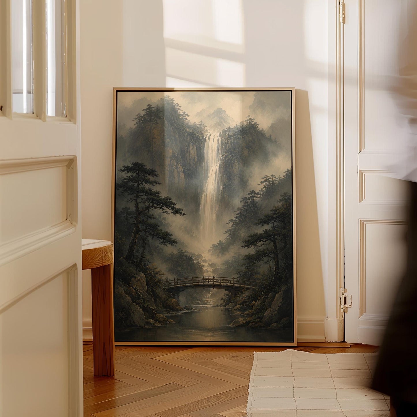 Tall waterfall and wooden bridge in a misty gorge, canvas print shown in a sunlit, contemporary room