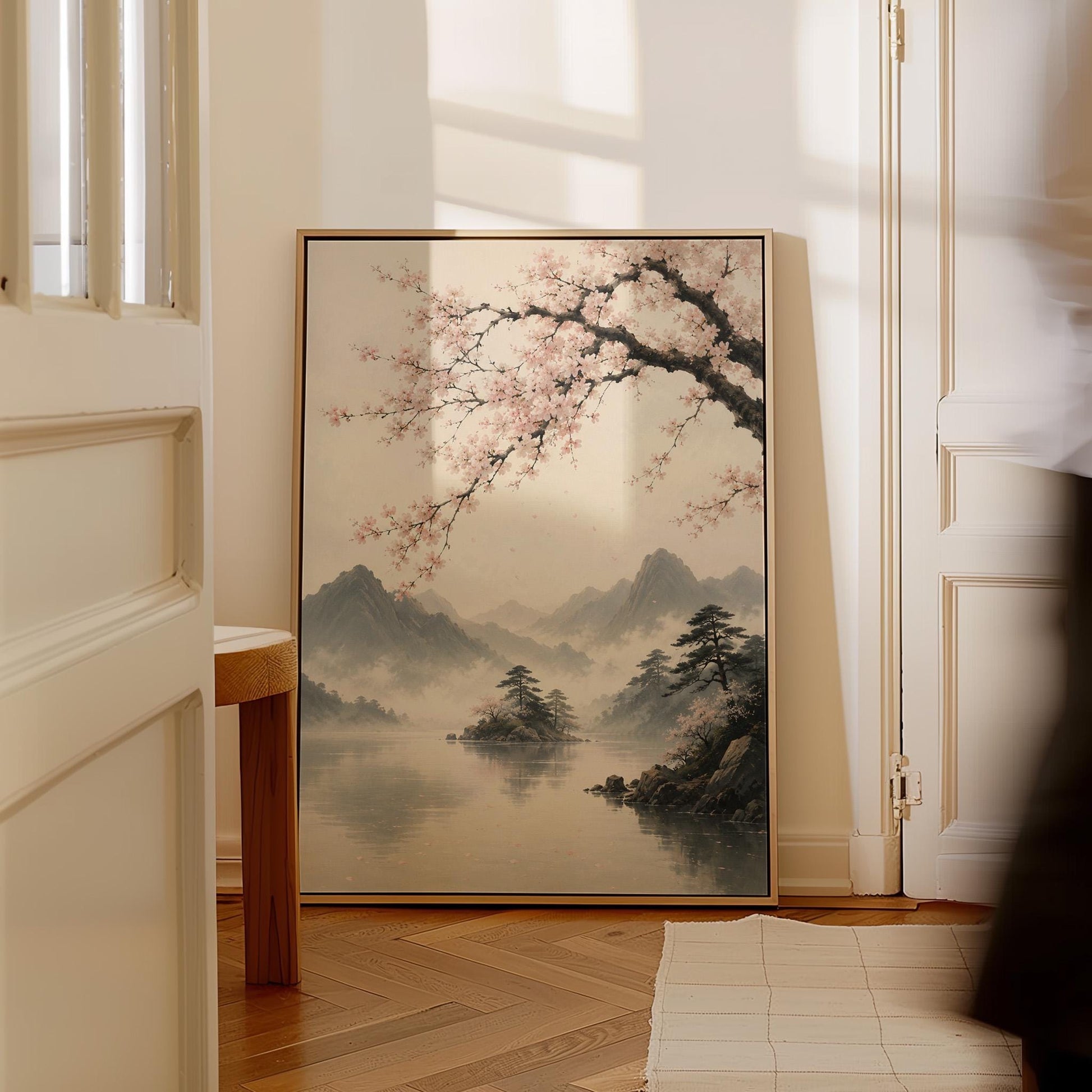 Cherry blossom branches over a misty mountain lake, canvas print hanging in a calm, modern living space