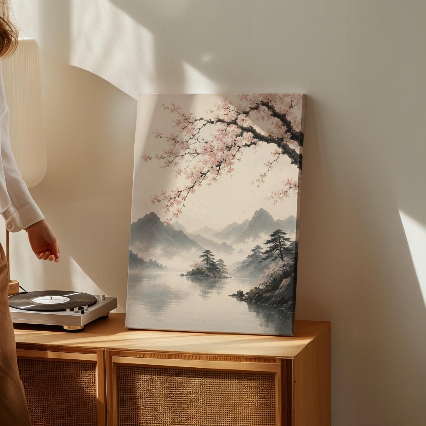 Cherry blossom branches over a misty mountain lake, canvas wall art seen in a warm interior with natural light