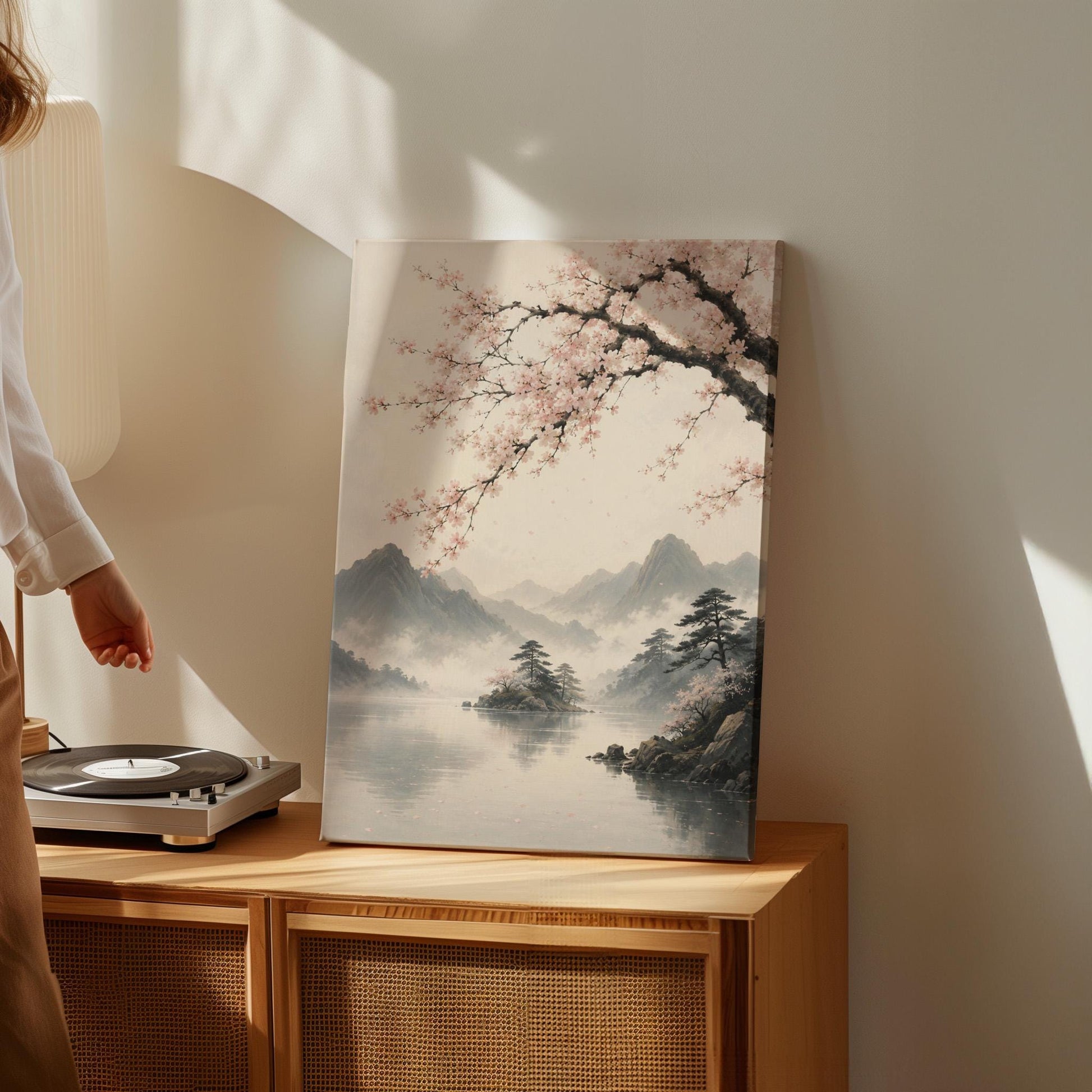 Cherry blossom branches over a misty mountain lake, canvas wall art seen in a warm interior with natural light