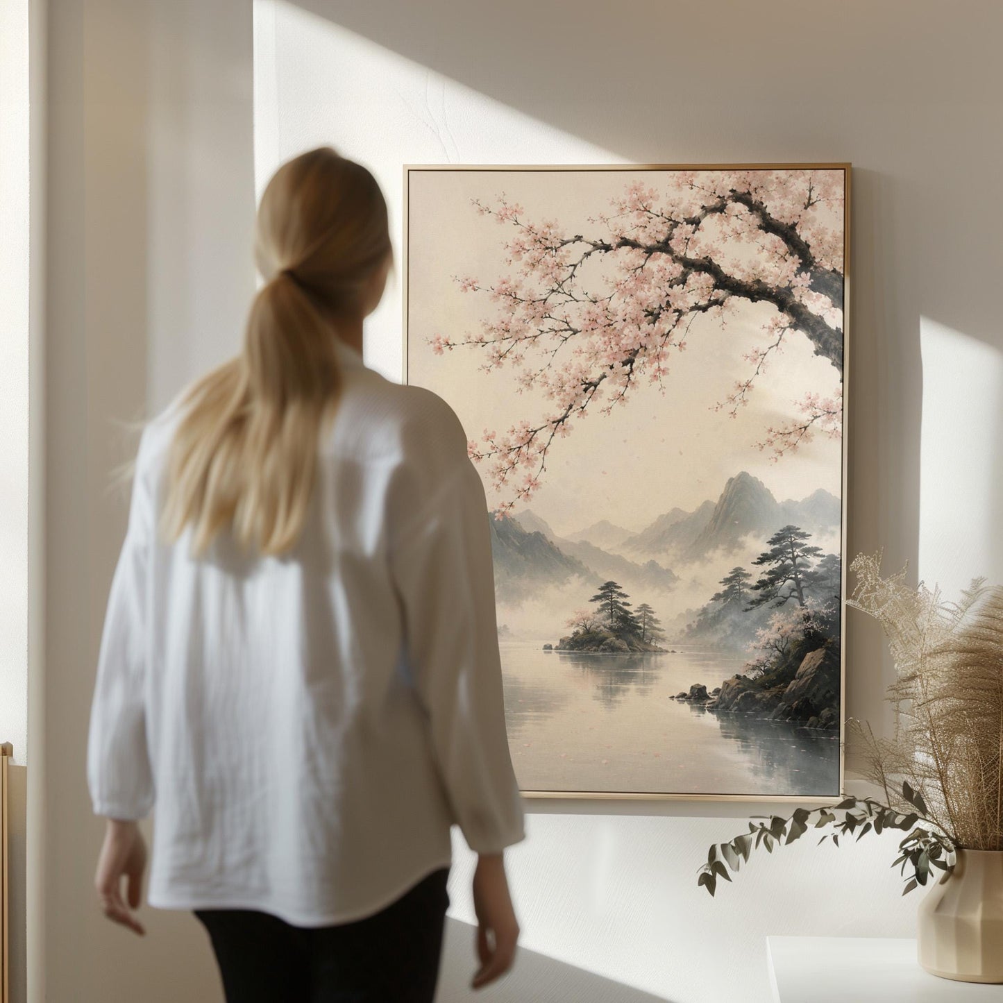 Cherry blossom branches over a misty mountain lake, canvas wall art presented in a light, minimal room