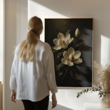Cream magnolia blooms and dark glossy leaves, canvas wall art hanging in a calm, modern living space