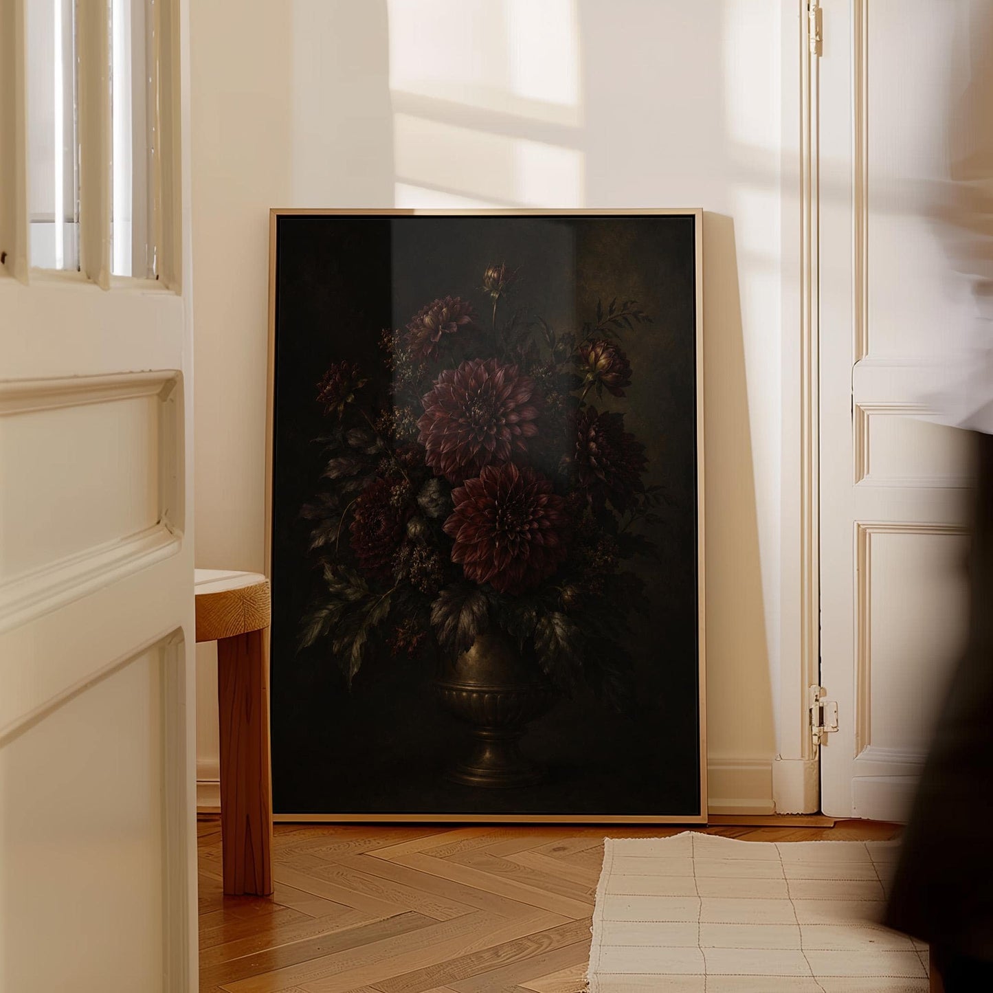 Burgundy dahlias in a brass urn against darkness, canvas wall art presented in a light, minimal room