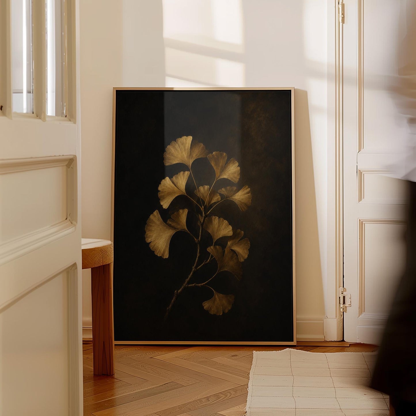 Golden ginkgo branch on a deep charcoal ground, canvas print hanging in a calm, modern living space