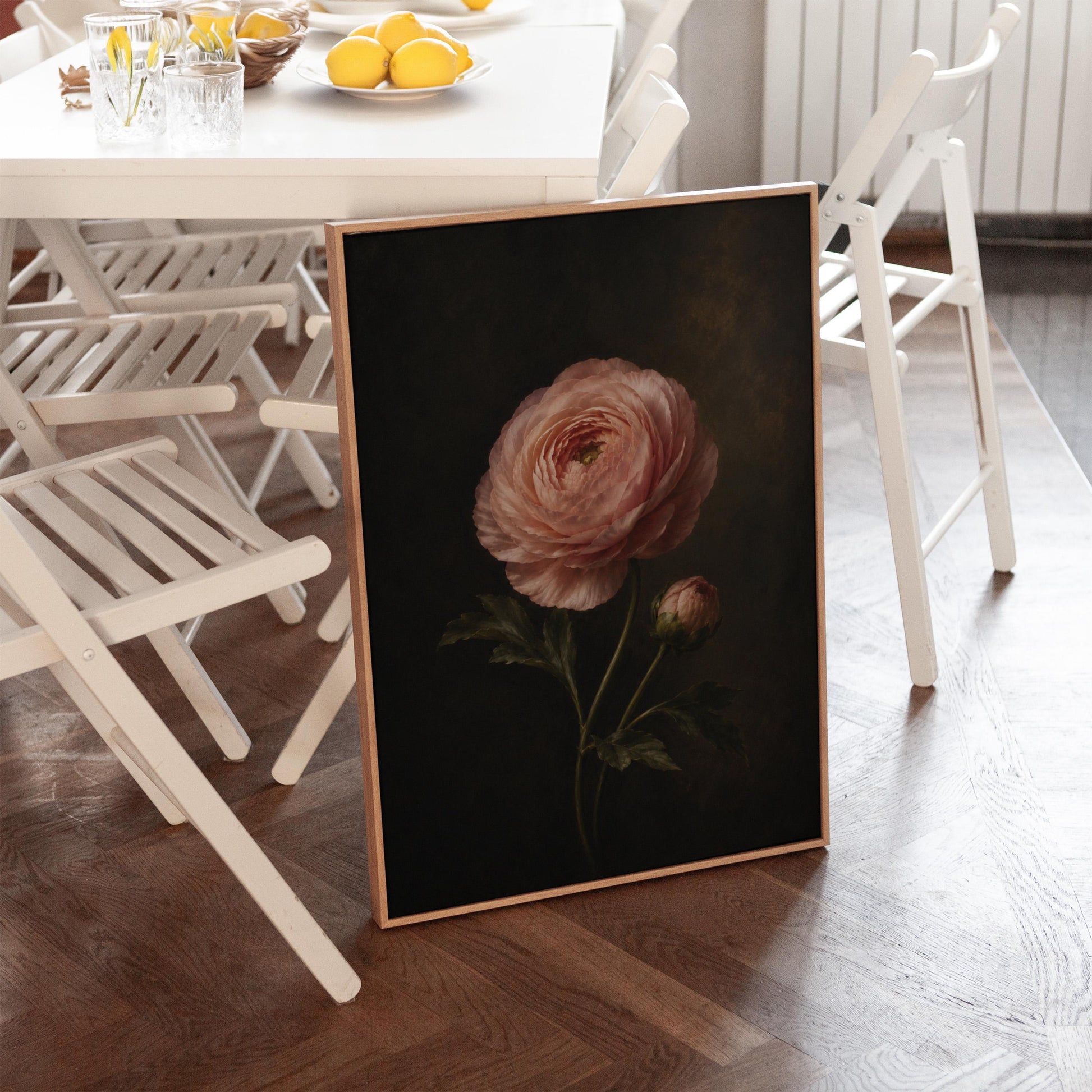 Single pink ranunculus bloom against dark shadow, canvas wall art on a quiet wall in a considered interior