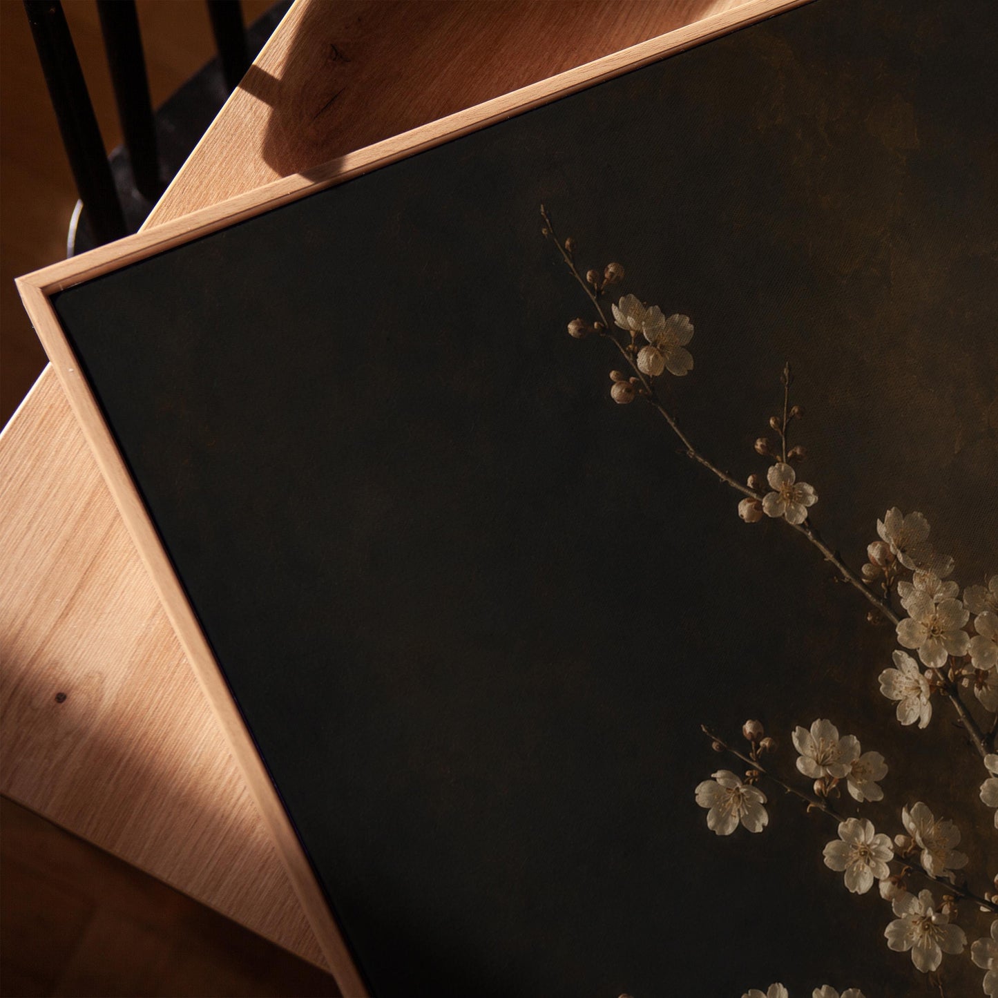 White blossom branch on a dark bronze ground, canvas print in a warm, minimally styled interior
