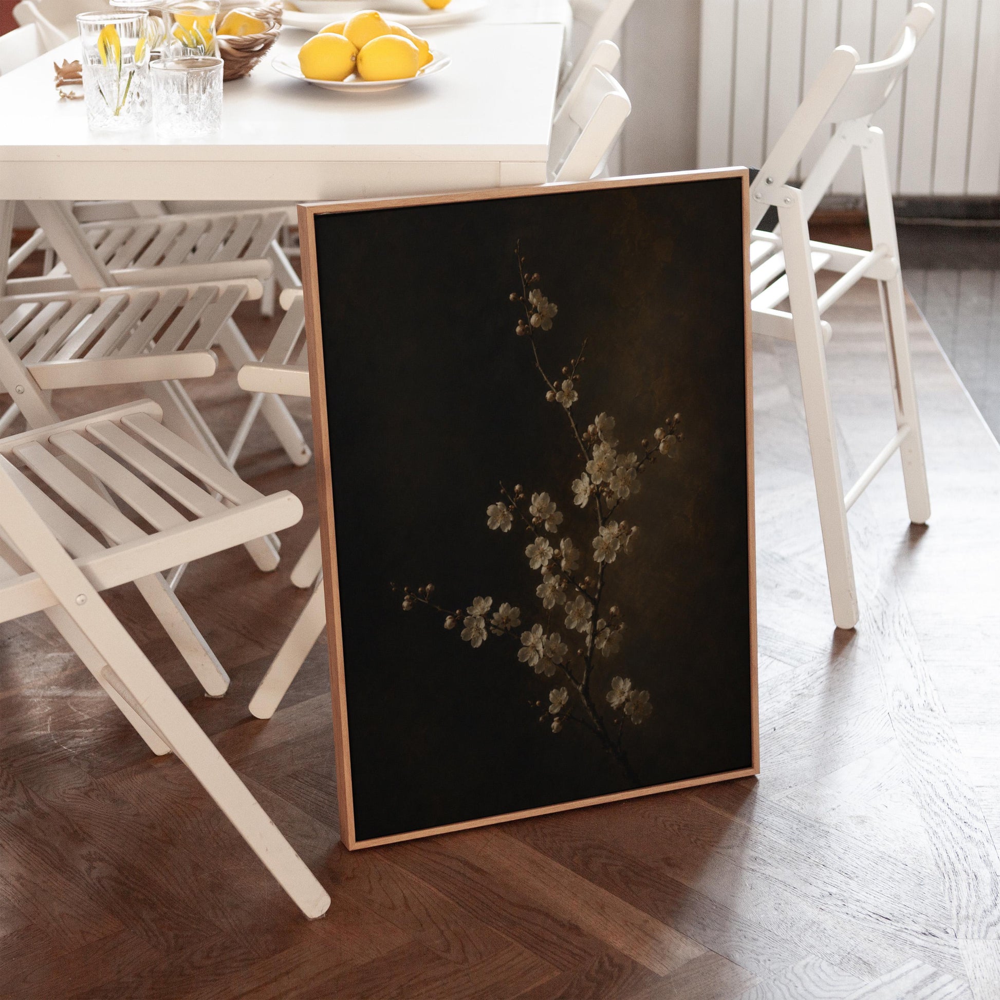 White blossom branch on a dark bronze ground, canvas print styled against a soft white wall