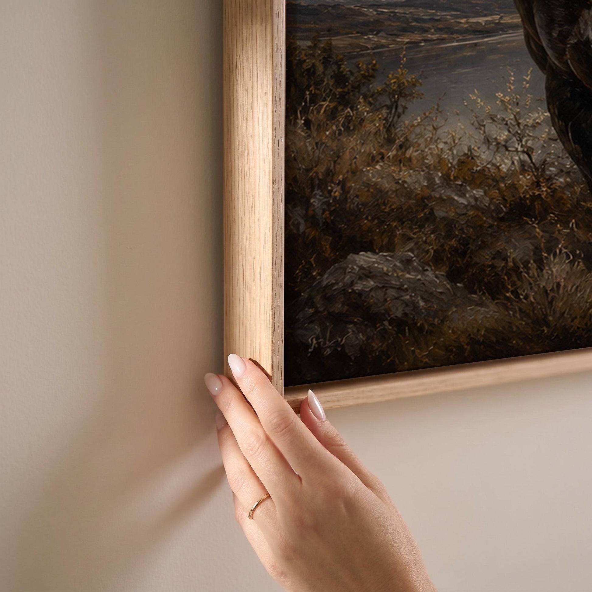 Black Friesian horse by a mountain lake under storm light, canvas print shown at full size in a light-filled bedroom