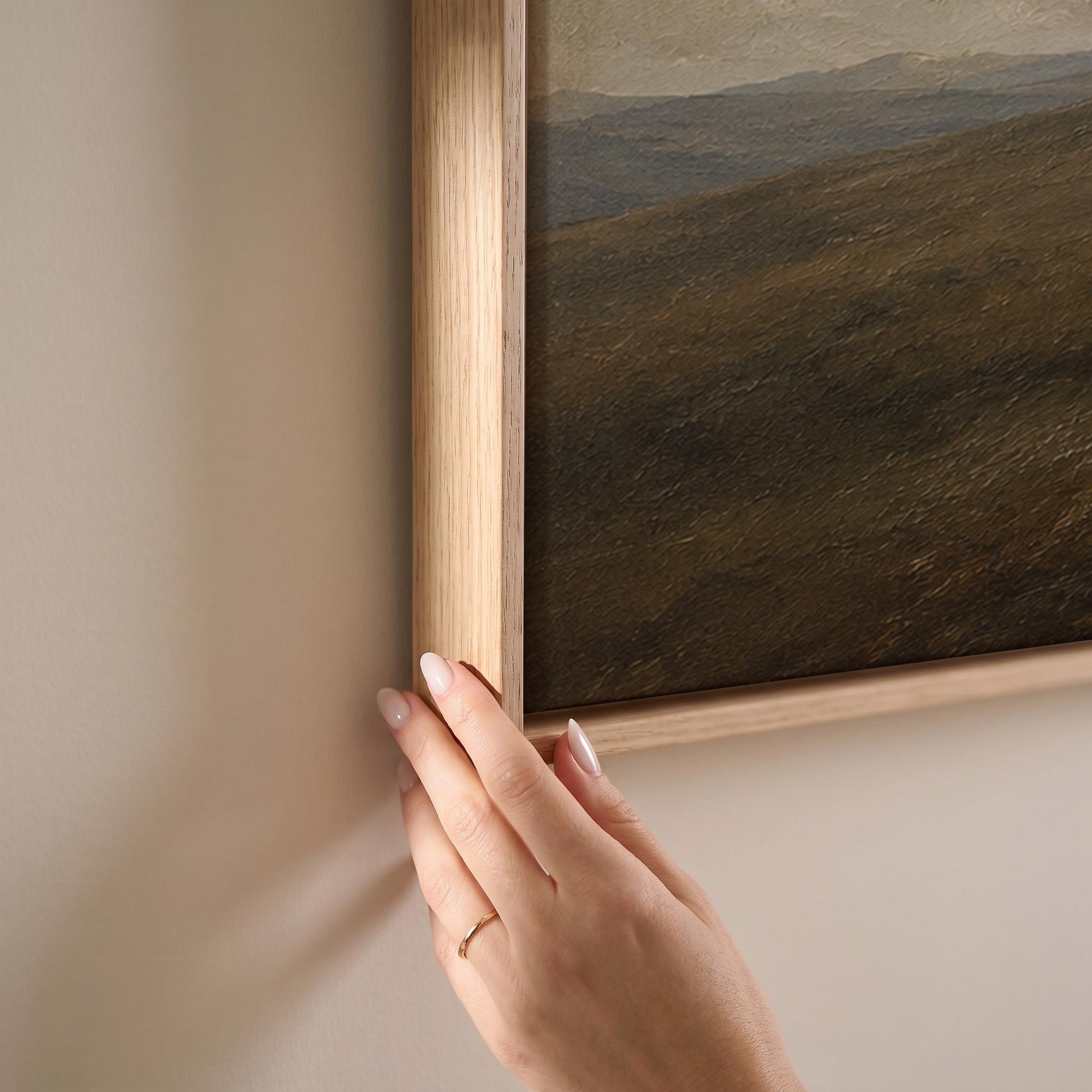 Distant herd of horses crossing a ridge under a vast cloudy sky, canvas print shown at full size in a light-filled bedroom