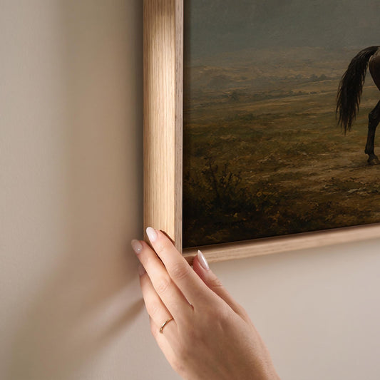 Dark horse in a meadow below a Tuscan villa with cypresses, canvas print shown at full size in a light-filled bedroom