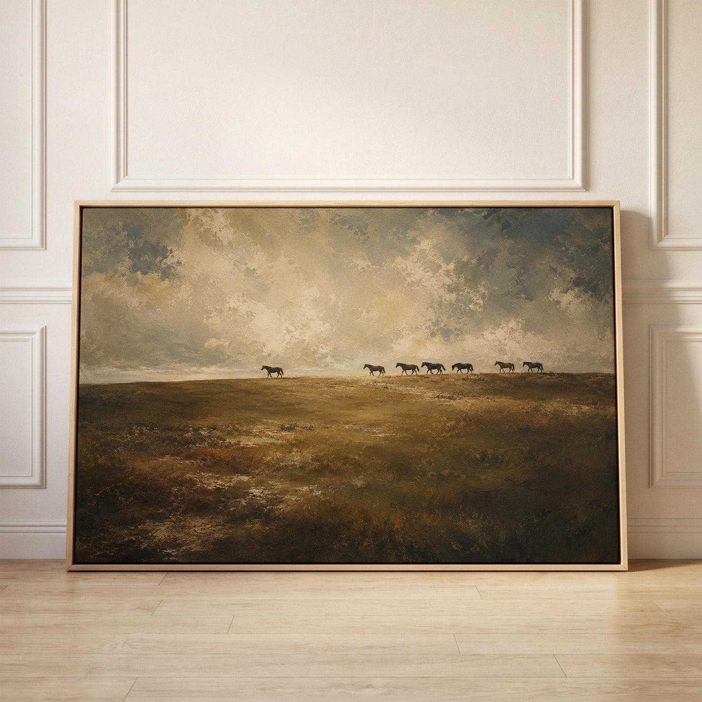 Row of horses on the far edge of a dark olive field, canvas print held up against a sunlit bedroom wall
