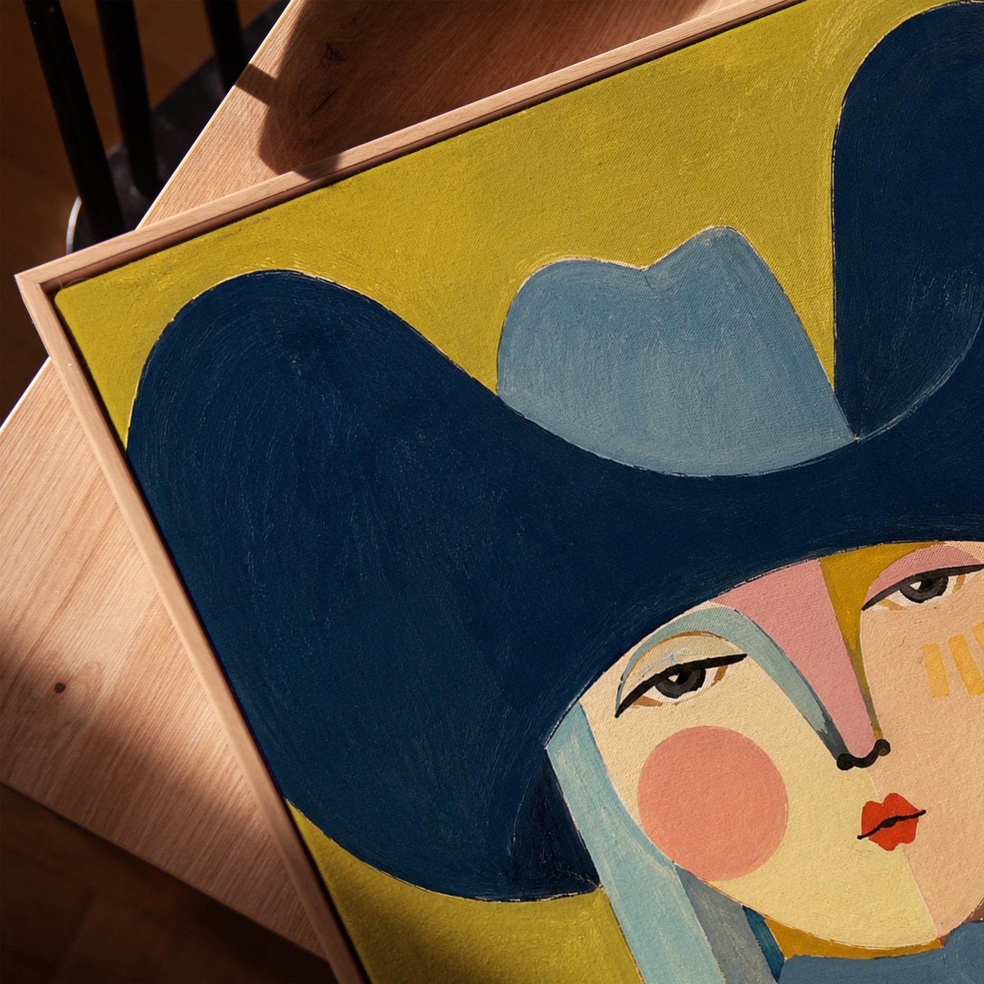 Folk cowgirl in an oversized navy hat and blue neckerchief on mustard, canvas print in a warm, minimally styled interior