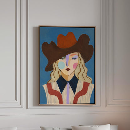 Blonde cowgirl in a rust cowboy hat with a cubist face on deep blue, canvas print in a bright room with natural daylight