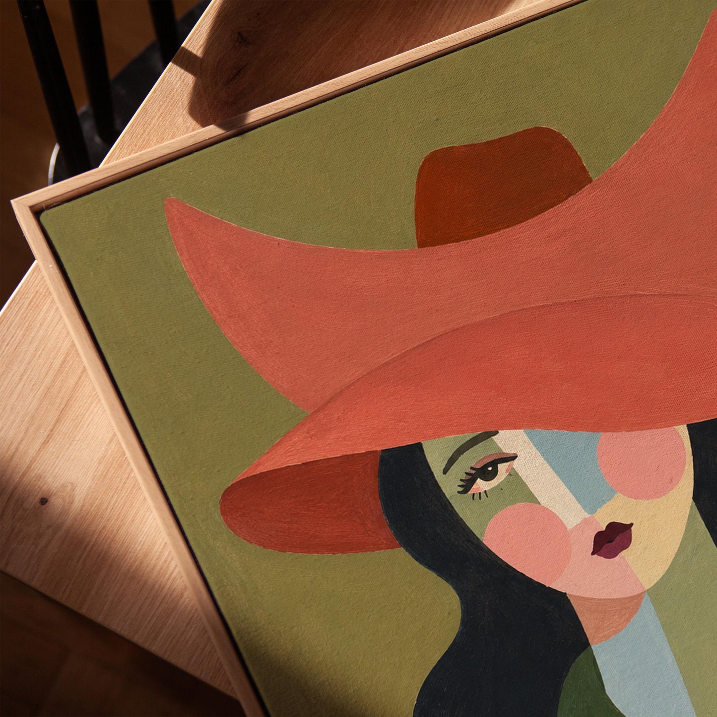 Cowgirl in a wide coral hat with a cubist face and cow-print collar on olive, canvas print in a warm, minimally styled interior