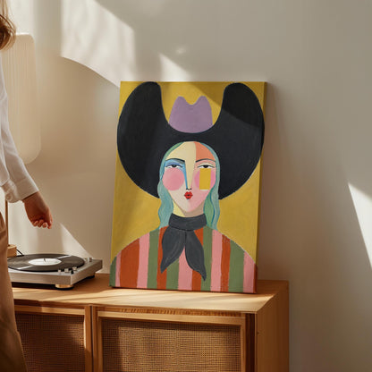 Folk cowgirl with teal hair, a big black hat and striped shirt on golden yellow, canvas wall art on a quiet wall in a considered interior