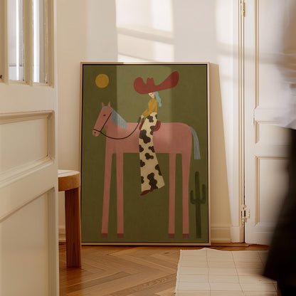 Cowgirl in a red hat riding a long-legged pink horse past a cactus at sunset, canvas print styled against a soft white wall